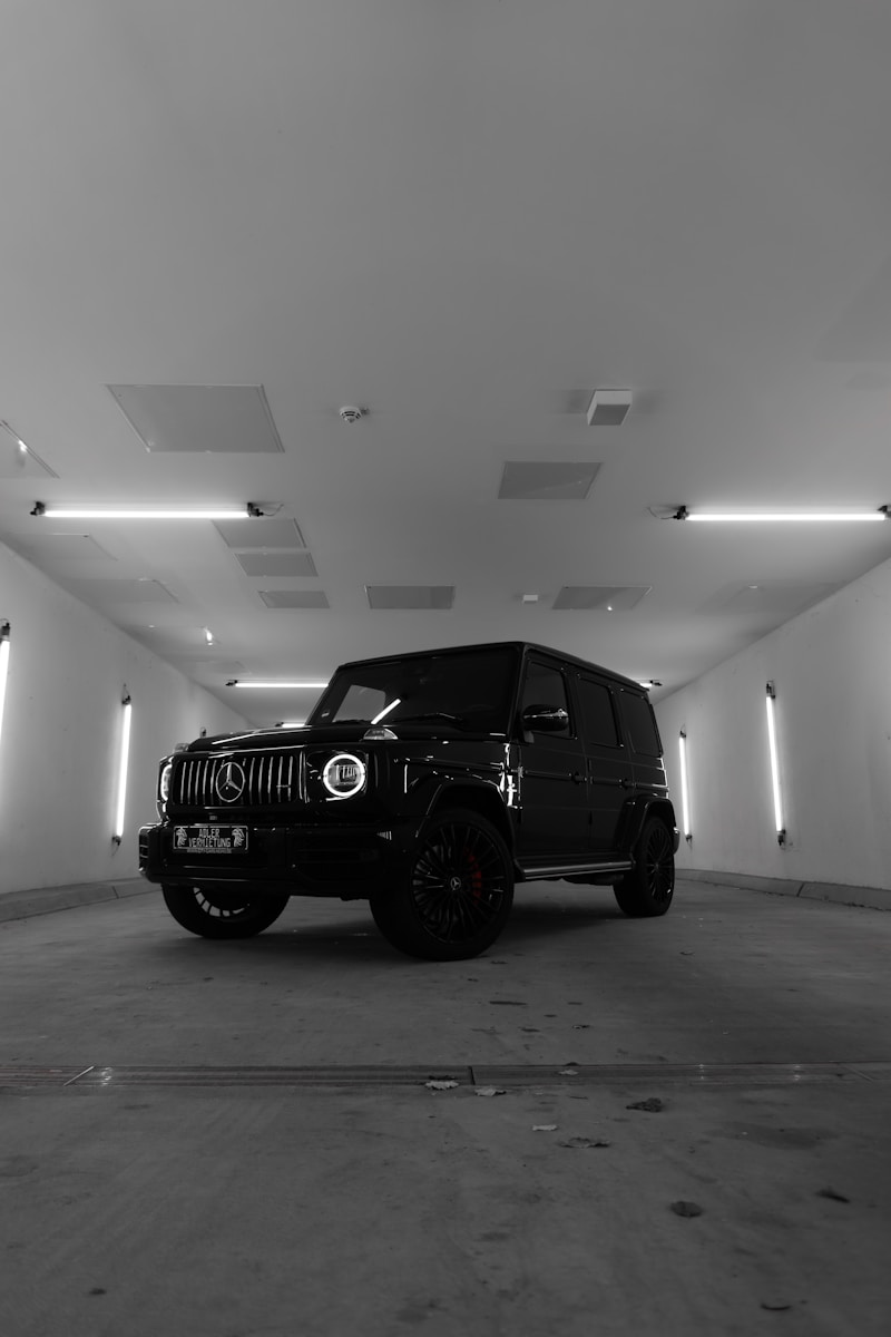A Black and White Photo of a Jeep in a Parking Garage
